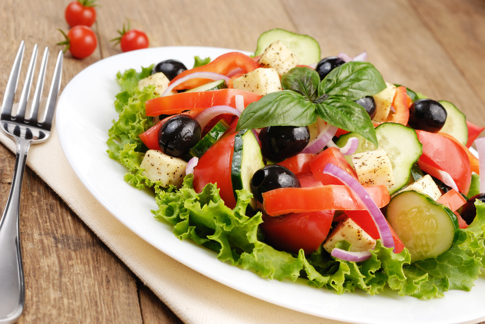 Greek salad served on the oak table